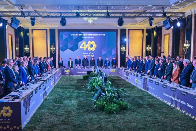 Participants including (From centre L) France's Special Envoy of the President of the French Republic for Ukraine's Relief and Reconstruction Muriel Lacoue-Labarthe and President of the European Bank for Reconstruction and Development (BERD) Odile Renaud-Basso, European Commissioner for Energy and Housing Dan Jørgensen, Ukraine's Minister of Energy Denys Shmyhal, Ukraine's Prime Minister Yulia Svyrydenko, EU Commissioner for Economy and Productivity, Implementation and Simplification Valdis Dombrovskis, chief of the U.N.s International Atomic Energy Agency (IAEA) Rafael Mariano Grossi and European Commission's Deputy Director-General for the Directorate-General for Energy Mechthild Wörsdörfer attend Ukraine Energy Coordination Group summit on the 40th anniversary of the explosion at the Chernobyl nuclear power plant, in Kyiv on April 26, 2026, amid the Russian invasion of Ukraine. Ukraine on April 26, 2026, marks the 40th anniversary of the explosion at the Chernobyl nuclear power plant. It comes four years into the Russian invasion that has put the plant once again under threat and raised risks of another radioactive catastrophe. The 1986 explosion at the Chernobyl nuclear power plant was the worst civilian nuclear disaster in history and changed global perceptions of nuclear energy. (Photo by Sergei SUPINSKY / AFP)