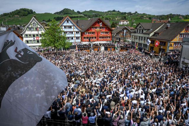 Citizens vote by raising their hands during the Landsgemeinde, a traditional public, non-secret ballot conducted by majority rule, in Appenzell, eastern Switzerland, on April 26, 2026. The open-air gathering, held annually, allows eligible citizens to decide cantonal laws and policies directly, preserving one of Switzerland’s oldest forms of direct democracy. (Photo by Fabrice COFFRINI / AFP)