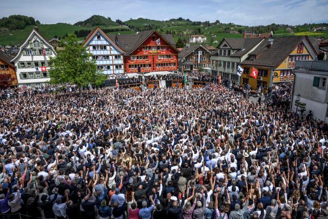 Citizens vote by raising their hands during the Landsgemeinde, a traditional public, non-secret ballot conducted by majority rule, in Appenzell, eastern Switzerland, on April 26, 2026. The open-air gathering, held annually, allows eligible citizens to decide cantonal laws and policies directly, preserving one of Switzerland’s oldest forms of direct democracy. (Photo by Fabrice COFFRINI / AFP)