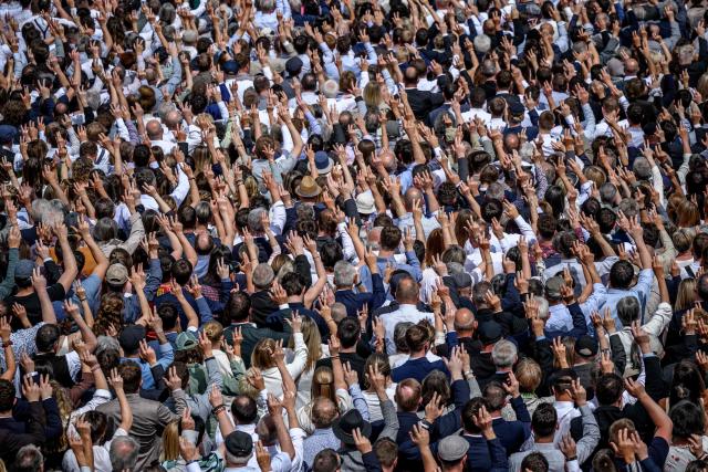 Citizens vote by raising their hands during the Landsgemeinde, a traditional public, non-secret ballot conducted by majority rule, in Appenzell, eastern Switzerland, on April 26, 2026. The open-air gathering, held annually, allows eligible citizens to decide cantonal laws and policies directly, preserving one of Switzerland’s oldest forms of direct democracy. (Photo by Fabrice COFFRINI / AFP)
