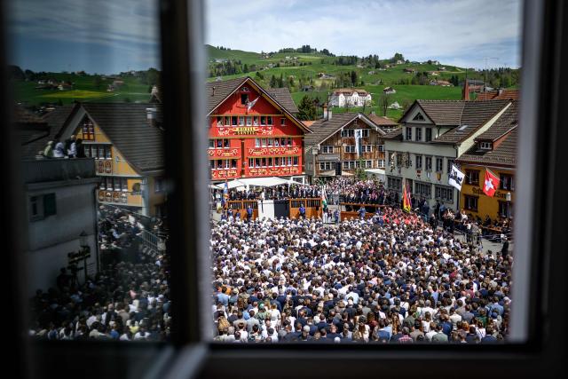 Citizens take part in the Landsgemeinde, a traditional public, non-secret ballot conducted by majority rule, in Appenzell, eastern Switzerland, on April 26, 2026. The open-air gathering, held annually, allows eligible citizens to decide cantonal laws and policies directly, preserving one of Switzerland’s oldest forms of direct democracy. (Photo by Fabrice COFFRINI / AFP)