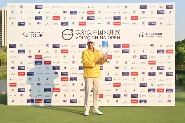 Austria's Bernd Wiesberger poses with the trophy after winning the China Open golf tournament in Shanghai on April 26, 2026. (Photo by CN-STR / AFP) / China OUT