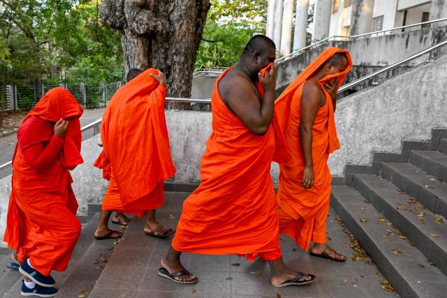 Sri Lankan monks arrive to appear before a court after their arrest in Negombo on April 26, 2026. Twenty-two Sri Lankan monks returning from Thailand were arrested on April 26 at the main international airport with 110 kilograms (242 pounds) of powerful cannabis, officials said. (Photo by Ishara S. KODIKARA / AFP)