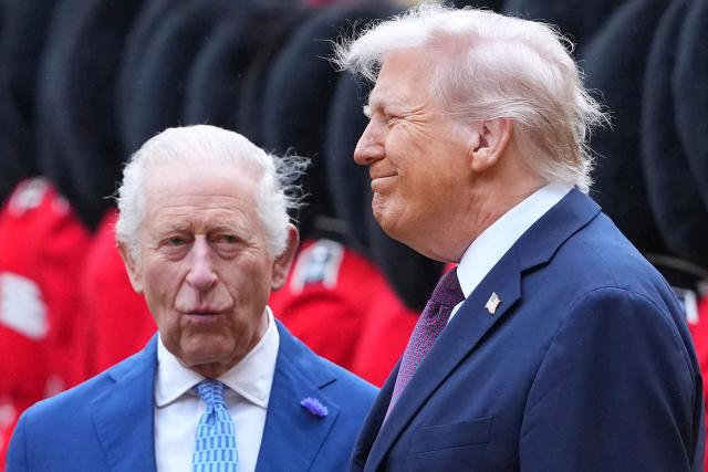 (FILES) US President Donald Trump (R) and Britain's King Charles III inspect a guard of honour during a ceremonial welcome in the Quadrangle at Windsor Castle in Windsor on September 17, 2025, during the US president's second state visit. King Charles III was "greatly relieved" US President Donald Trump, his wife Melania Trump and other guests were unharmed after a shooting at a Washington media gala, Buckingham Palace said on April 26, 2026. (Photo by Kirsty Wigglesworth / POOL / AFP)