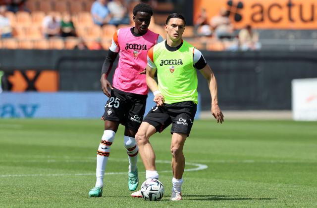 Lorient's Greek midfielder Panos Katseris #77 (R) and Senegalese defender #25 Abdoulaye Faye warm up before the French Ligue 1 football match between FC Lorient and RC Strasbourg Alsace at the Stade du Moustoir in Lorient, western France on April 26, 2026. (Photo by Fred TANNEAU / AFP)