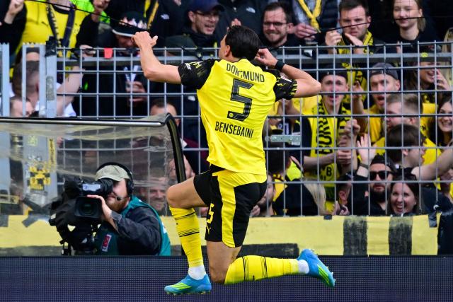 Dortmund's Algerian defender #05 Ramy Bensebaini celebrates scoring the 3-0 goal in front of their fans during the German first division Bundesliga football match between BVB Borussia Dortmund and SC Freiburg in Dortmund, western Germany on April 26, 2026. (Photo by INA FASSBENDER / AFP) / DFL REGULATIONS PROHIBIT ANY USE OF PHOTOGRAPHS AS IMAGE SEQUENCES AND/OR QUASI-VIDEO  ALTERNATIVE CROP