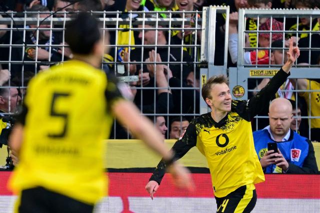Dortmund's German forward #14 Maximilian Beier (R) celebrates scoring the opening goal with his teammates during the German first division Bundesliga football match between BVB Borussia Dortmund and SC Freiburg in Dortmund, western Germany on April 26, 2026. (Photo by INA FASSBENDER / AFP) / DFL REGULATIONS PROHIBIT ANY USE OF PHOTOGRAPHS AS IMAGE SEQUENCES AND/OR QUASI-VIDEO  ALTERNATIVE CROP