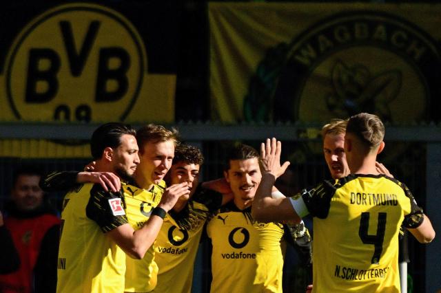 Dortmund's German forward #14 Maximilian Beier (2nd L) celebrates scoring the opening goal with his teammates during the German first division Bundesliga football match between BVB Borussia Dortmund and SC Freiburg in Dortmund, western Germany on April 26, 2026. (Photo by INA FASSBENDER / AFP) / DFL REGULATIONS PROHIBIT ANY USE OF PHOTOGRAPHS AS IMAGE SEQUENCES AND/OR QUASI-VIDEO  ALTERNATIVE CROP