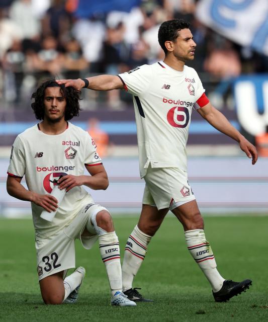 Lille's French midfielder #32 Ayyoub Bouaddi (L) and Lille's French midfielder #21 Benjamin Andre (R) react during the French L1 football match between Paris FC and LOSC Lille at the Stade Jean-Bouin in Paris, on April 26, 2026. (Photo by FRANCK FIFE / AFP)