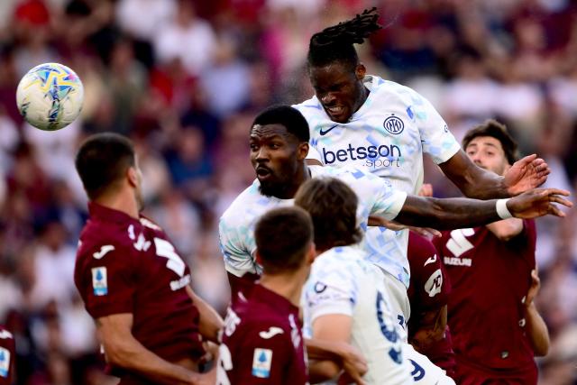 Inter Milan's German defender #31 Yann Aurel Bisseck (2R) heads the ball to score Inter's second goal during the Italian Serie A football match between Torino and Inter Milan at the Olympic Stadium Grande Torino in Turin on April 26, 2026. (Photo by MARCO BERTORELLO / AFP)