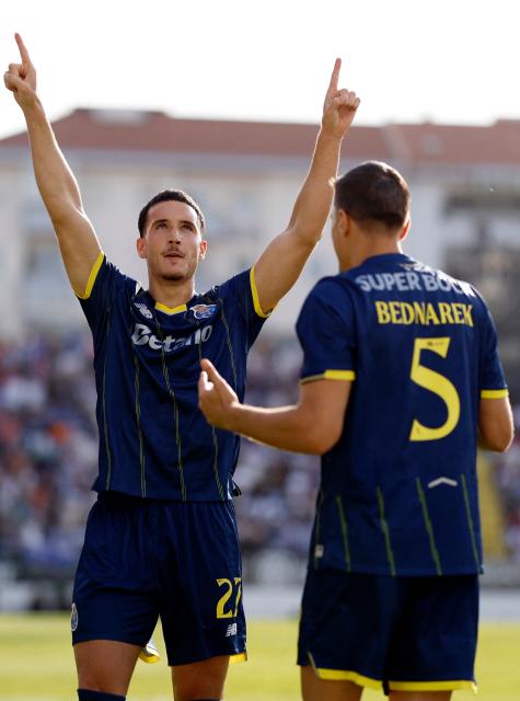 FC Porto's Turkish forward #27 Deniz Gul celebrates scoring the opening goal during the Portuguese League football match between CF Estrela da Amadora and FC Porto at Jose Gomes stadium in Amadora, on April 26, 2026. (Photo by FILIPE AMORIM / AFP)