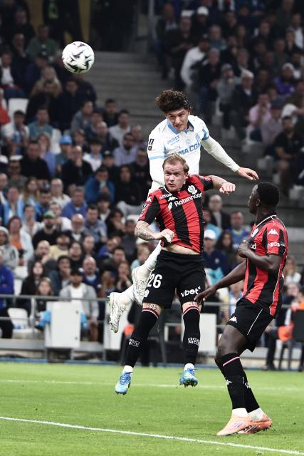 Marseille's Argentinian defender #05 Leonardo Balerdi (top) heads the ball during the French Ligue 1 football match between Olympique de Marseille (OM) and OGC Nice at the Velodrome stadium in Marseille, south-eastern France on April 26, 2026. (Photo by Thibaud MORITZ / AFP)