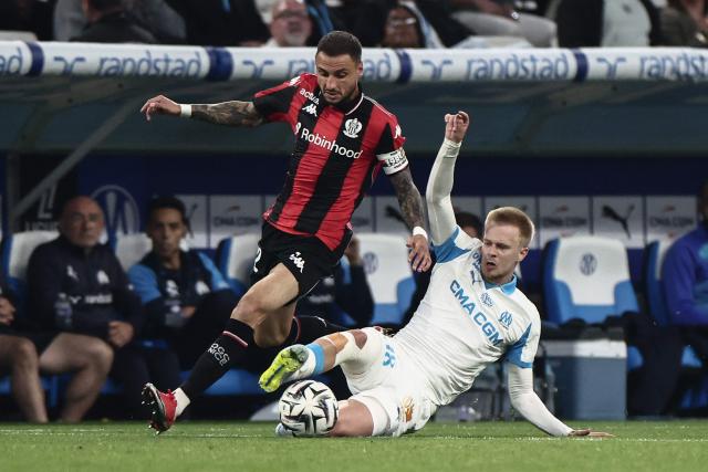 Nice's French defender #92 Jonathan Clauss (L) is tackled by Marseille's Belgian midfielder #18 Arthur Vermeeren (R) during the French Ligue 1 football match between Olympique de Marseille (OM) and OGC Nice at the Velodrome stadium in Marseille, south-eastern France on April 26, 2026. (Photo by Thibaud MORITZ / AFP)