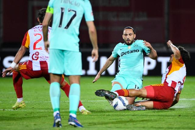 Sporting Lisbon's Georgian midfielder #14 Giorgi Kochorashvili is tackled by AVS' Brazilian midfielder #08 Pedro Lima (R) during the Portuguese League football match between AVS Futebol SAD and Sporting CP at CD Aves stadium in Vila das Aves on April 26, 2026. (Photo by MIGUEL LEMOS / AFP)