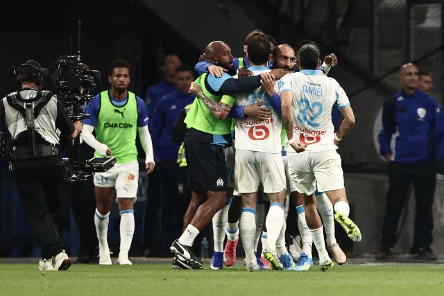 Marseille's players celebrate scoring their first goal during the French Ligue 1 football match between Olympique de Marseille (OM) and OGC Nice at the Velodrome stadium in Marseille, south-eastern France on April 26, 2026. (Photo by Thibaud MORITZ / AFP)
