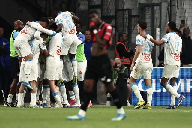 Marseille's players celebrate scoring their first goal during the French Ligue 1 football match between Olympique de Marseille (OM) and OGC Nice at the Velodrome stadium in Marseille, south-eastern France on April 26, 2026. (Photo by Thibaud MORITZ / AFP)