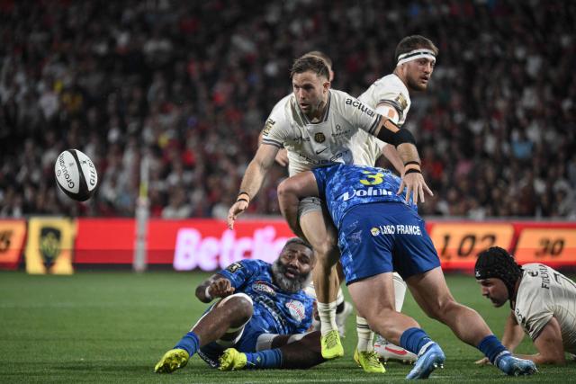 CORRECTION / Toulouse's French scrum-half Paul Graou eyes the ball as he is tackled during the French Top 14 rugby union match between Stade Toulousain and ASM Clermont Auvergne at the Ernest Wallon Stadium in Toulouse, southwestern France, on April 26, 2026. (Photo by Ed JONES / AFP) / “The erroneous mention[s] appearing in the metadata of this photo by Ed JONES has been modified in AFP systems in the following manner: [Toulouse's French scrum-half Paul Graou] instead of [Toulouse's English flanker Jack Willis]. Please immediately remove the erroneous mention[s] from all your online services and delete it (them) from your servers. If you have been authorized by AFP to distribute it (them) to third parties, please ensure that the same actions are carried out by them. Failure to promptly comply with these instructions will entail liability on your part for any continued or post notification usage. Therefore we thank you very much for all your attention and prompt action. We are sorry for the inconvenience this notification may cause and remain at your disposal for any further information you may require.”