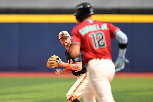 San Diego Padres' #09 Jake Cronenworth prepares to throw to first base past Arizona Diamondbacks' #12 Lourdes Gurriel Jr. during the MLB World Tour Mexico City Series game between the Arizona Diamondbacks and the San Diego Padres at Alfredo Harp Helu Stadium in Mexico City on April 26, 2026. (Photo by YURI CORTEZ / AFP)