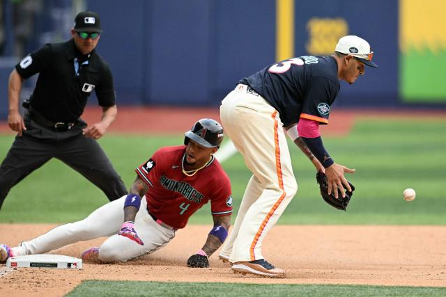 Arizona Diamondbacks' #04 Ketel Marte slides into third base past San Diego Padres' #13 Manny Machado during the MLB World Tour Mexico City Series game between the Arizona Diamondbacks and the San Diego Padres at Alfredo Harp Helu Stadium in Mexico City on April 26, 2026. (Photo by YURI CORTEZ / AFP)