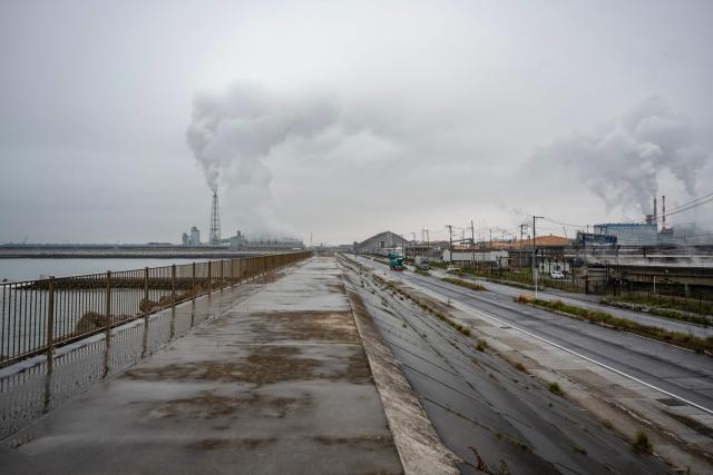 Steam rises out of a power station protected by a tsunami sea wall in Ishinomaki, Miyagi Prefecture on April 27, 2026. A strong earthquake rattled Japan's northern island of Hokkaido early on April 27, US and Japanese meteorological agencies reported, the latest in a series of powerful tremors to hit the island nation. (Photo by ANDREW CABALLERO-REYNOLDS / AFP)