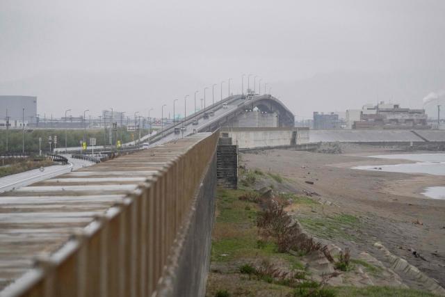 Cars drive over a bridge protected by a tsunami sea wall in Ishinomaki, Miyagi Prefecture on April 27, 2026. A strong earthquake rattled Japan's northern island of Hokkaido early on April 27, US and Japanese meteorological agencies reported, the latest in a series of powerful tremors to hit the island nation. (Photo by ANDREW CABALLERO-REYNOLDS / AFP)