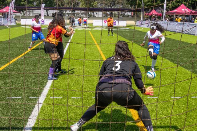 Players of Puebla's Topas and Mexicali's Linces fight for the ball during the women’s final of the football tournament of the sight-impaired people at the Utopia Mixihuca sport complex in Mexico City on April 26, 2026. (Photo by Gerardo MAGALLON / AFP)