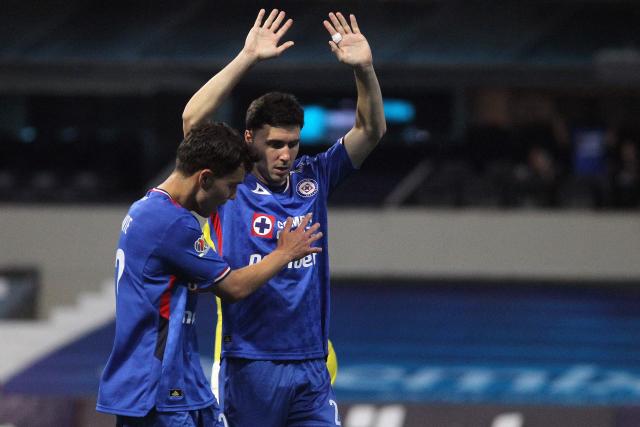 Cruz Azul's Argentine forward #20 Jose Paradela celebrates with teammate defender #22 Jorge Rodarte (L) after scoring the opening goal during the Liga MX Clausura football match between Cruz Azul and Necaxa at Banorte Stadium in Mexico City on April 26, 2026. (Photo by Victor Cruz / AFP)