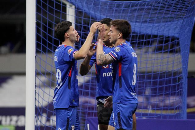 Cruz Azul's Argentine midfielder #08 Agustin Palavecino (R) celebrates with teammates after scoring his team's second goal during the Liga MX Clausura football match between Cruz Azul and Necaxa at Banorte Stadium in Mexico City on April 26, 2026. (Photo by Victor Cruz / AFP)