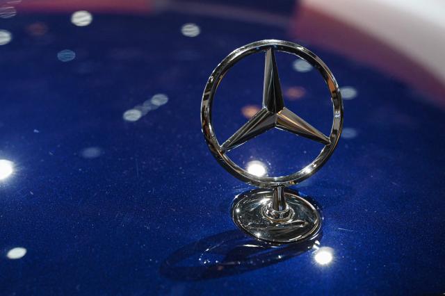 A Mercedes-Benz crest is seen on one of the German automaker's cars at the Beijing Auto Show in Beijing on April 24, 2026. (Photo by JADE GAO / AFP)