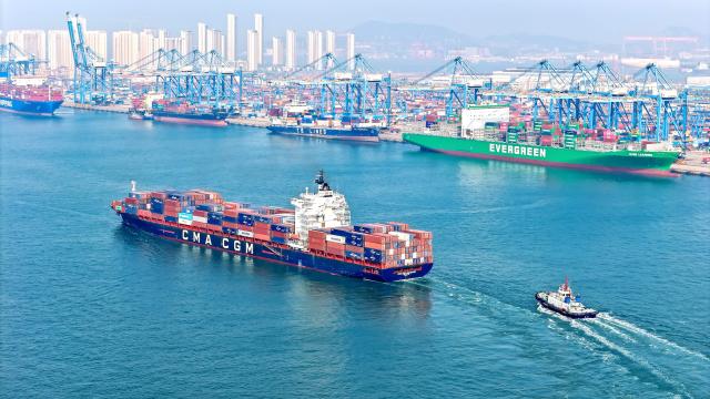 This picture taken on April 26, 2026 shows a cargo ship sailing from Qianwan Container Terminal of Qingdao port, in China’s eastern Shandong province. (Photo by CN-STR / AFP) / China OUT