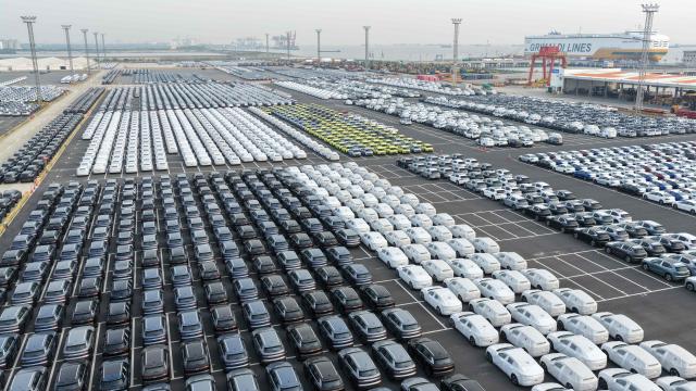 Chinese-made vehicles including BYD cars (L) wait to be transshipped for export at a port in Suzhou, in China’s eastern Jiangsu province on April 27, 2026. (Photo by CN-STR / AFP) / China OUT