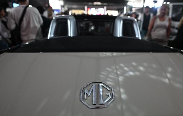 A logo of the British MG Automoblie Company on a car is pictured during the 14th edition of Venezuela’s largest automotive exhibition, "AutoFest 2026," at the Centro Comercial Ciudad Tamanaco (CCCT) in Caracas on April 26, 2026. (Photo by Juan BARRETO / AFP)