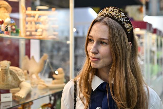 A woman wearing a kokoshnik - Russian traditional headdress, is seen at the fair of folk and arts craft of Russia, in central Moscow on March 4, 2026. (Photo by Hector RETAMAL / AFP)