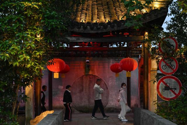 People visit the Fengjing Ancient Town on the outskirts of Shanghai on April 26, 2026. (Photo by ADEK BERRY / AFP)