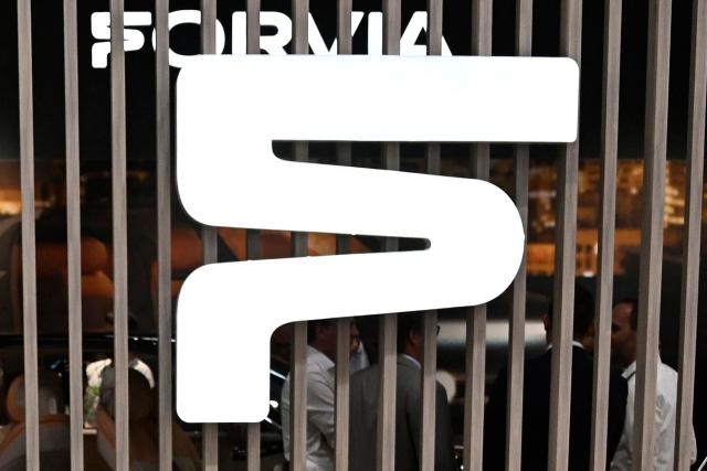 (FILES) This photograph shows a view of the booth of automotive technology supplier Forvia with the company logo during the International Motor Show IAA in Munich, southern Germany, on September 6, 2023. The French automotive supplier Forvia announced on April 27, 2026, that it is selling its interior fittings division (dashboards, door panels, center consoles, etc.) to the American asset manager Apollo, in a deal valuing the business at 1.82 billion euros. (Photo by Tobias SCHWARZ / AFP)