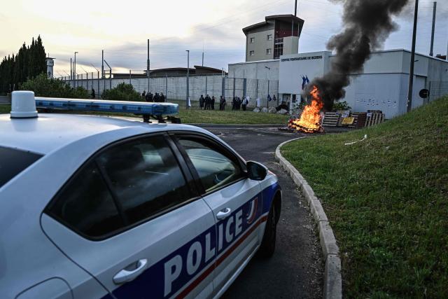 Penitentiary staff take part in a day of strike, blocking off access at the entrance of the prison of Beziers, southern France, on April 27, 2026. CGT and Ufap-Unsa unions call for a blockade of prisons on Monday, April 27 to alert about prison overcrowding and "fill the 5,000 missing positions." (Photo by Gabriel BOUYS / AFP)