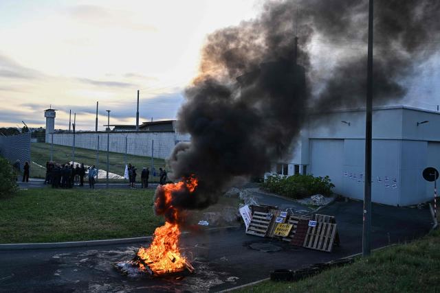 Penitentiary staff take part in a day of strike, blocking off access at the entrance of the prison of Beziers, southern France, on April 27, 2026. CGT and Ufap-Unsa unions call for a blockade of prisons on Monday, April 27 to alert about prison overcrowding and "fill the 5,000 missing positions." (Photo by Gabriel BOUYS / AFP)