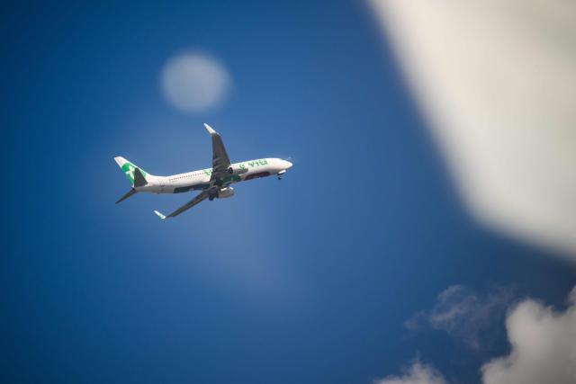 (FILES) A Boeing 737-8K2 of low-cost Air France subsidiary Transavia flies over Nantes, western France, on April 13, 2026. Transavia, the low-cost carrier of the Air France-KLM group, will adjust its scheduled flight program for May and June 2026 to optimize its costs in response to the surge in kerosene prices linked to the war in the Middle East, a spokesperson told AFP on April 26, 2026, confirming a report by RMC. (Photo by Loic VENANCE / AFP)