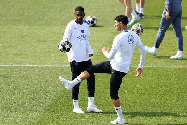 Paris Saint-Germain's French forward #10 Ousmane Dembele (L) and Paris Saint-Germain's Moroccan defender #02 Achraf Hakimi take part in a training session of French football club Paris Saint-Germain a day ahead of their UEFA Champions League semi-final match against German club FC Bayern Munich at the PSG Campus in Poissy, north-west of Paris, on April 27, 2026. (Photo by FRANCK FIFE / AFP)