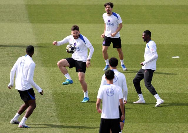 Paris Saint-Germain's Georgian forward #07 Khvicha Kvaratskhelia (L), Paris Saint-Germain's Portuguese midfielder #17 Vitinha (C, up) and Paris Saint-Germain's French forward #10 Ousmane Dembele (R) take part in a training session of French football club Paris Saint-Germain a day ahead of their UEFA Champions League semi-final match against German club FC Bayern Munich at the PSG Campus in Poissy, north-west of Paris, on April 27, 2026. (Photo by FRANCK FIFE / AFP)