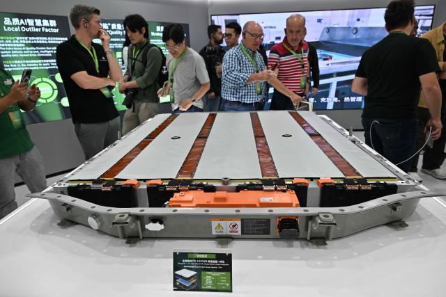 Journalists visit a gallery at a Leap Energy factory owned by Chinese automobile manufacturer Leapmotor in Huzhou, China’s Zhejiang province on April 26, 2026. (Photo by ADEK BERRY / AFP)