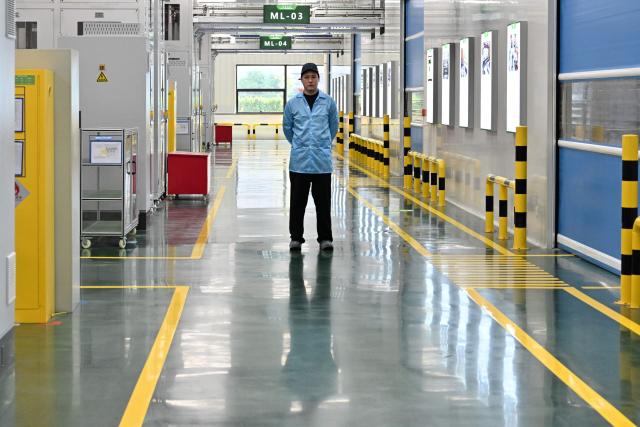 An employee works at a Leap Energy factory owned by Chinese automobile manufacturer Leapmotor in Huzhou, China’s Zhejiang province on April 26, 2026. (Photo by ADEK BERRY / AFP)