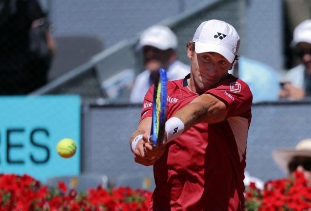 Norway’s Casper Ruud returns the ball to Spain’s Alejandro Davidovich Fokina during their 2026 ATP Tour Madrid Open tennis tournament third round singles match at the Caja Magica in Madrid, on April 27, 2026. (Photo by Thomas COEX / AFP)
