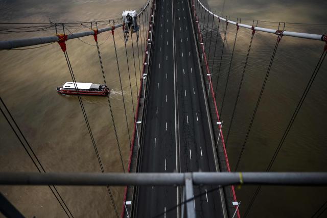 This picture shows the trafficless deck of the closed Pont d'Aquitaine (Aquitaine bridge) during a maintenance operation in Bordeaux, south-western France, on April 26, 2026. Routine maintenance work is carried out regularly on the suspension Aquitaine bridge connecting Bordeaux and its northern suburb of Lormont over the Garonne river. Triggering the closure of Bordeaux's ring road, maintenance work on the second-longest suspension bridge in France is generally performed at night or during week-ends. (Photo by Christophe ARCHAMBAULT / AFP)