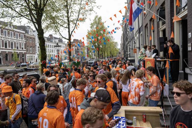 Revelers take part in King's Day celebrations in the Dutch capital Amsterdam on April 27, 2026. King's day is a national holiday in the Kingdom of the Netherlands and is celebrated on April 27, marking the birth of the Dutch King. (Photo by Michel van Bergen / ANP / AFP) / Netherlands OUT