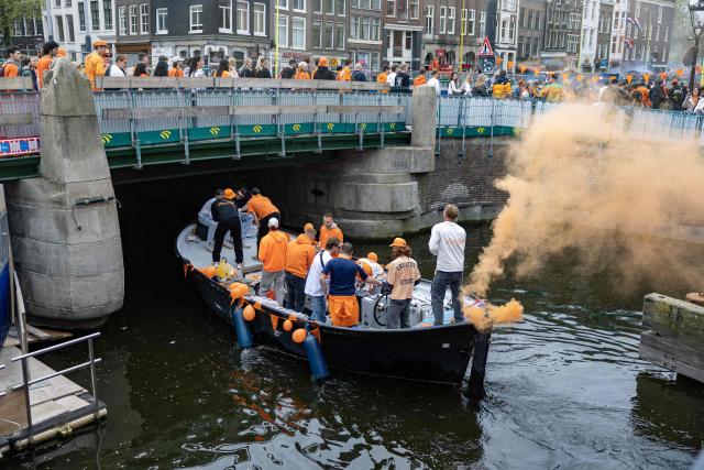 Revelers dressed in orange take part in King's Day celebrations in the Dutch capital Amsterdam on April 27, 2026. King's day is a national holiday in the Kingdom of the Netherlands and is celebrated on April 27, marking the birth of the Dutch King. (Photo by Michel van Bergen / ANP / AFP) / Netherlands OUT
