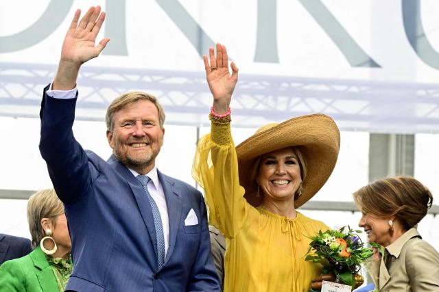 King Willem-Alexander of the Netherlands (L) and Queen Maxima of the Netherlands wave to the crowd during the King's Day celebrations, in Dokkum on April 27, 2026. King's day is a national holiday in the Kingdom of the Netherlands. Celebrated on 27 April the date marks the birth of King Willem-Alexander. (Photo by Mischa Schoemaker / various sources / AFP) / Netherlands OUT