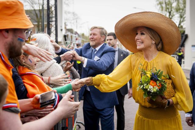 King Willem-Alexander of the Netherlands (C) and Queen Maxima of the Netherlands (R) shake hands with attendees during the King's Day celebrations, in Dokkum on April 27, 2026. King's day is a national holiday in the Kingdom of the Netherlands. Celebrated on 27 April the date marks the birth of King Willem-Alexander. (Photo by Sem van der Wal / various sources / AFP) / Netherlands OUT