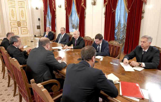 In this pool photograph distributed by the Russian state agency Sputnik, Russia's President Vladimir Putin and Iranian Foreign Minister Abbas Araghchi hold talks at the Boris Yeltsin Presidential Library in Saint Petersburg on April 27, 2026. (Photo by Alexei Danichev / POOL / AFP)