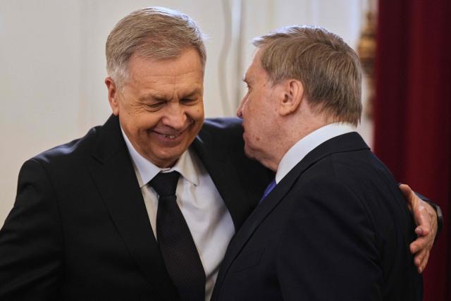 Admiral Igor Kostyukov, head of Russian military intelligence (GRU), and Kremlin foreign policy adviser Yuri Ushakov interact as they attend a meeting between Russian President and Iranian Foreign Minister at the Boris Yeltsin Presidential Library in Saint Petersburg on April 27, 2026. (Photo by Dmitry LOVETSKY / POOL / AFP)